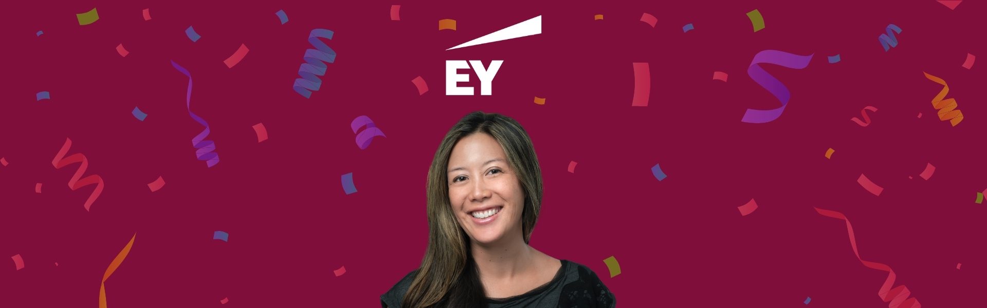 A person smiling in front of a maroon background with colorful confetti. The letters "EY" and a white logo are above.