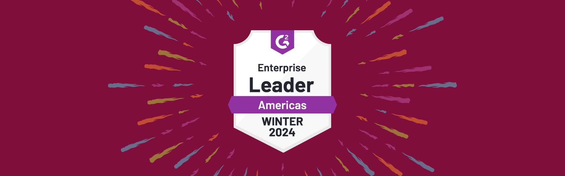 Award badge titled "Enterprise Leader Americas Winter 2024" on a maroon background, surrounded by colorful rays.