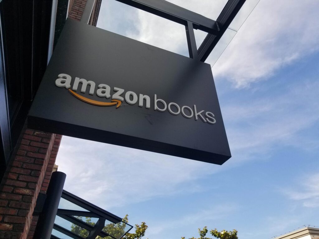Sign for Amazon Books on a building exterior with a blue sky background.