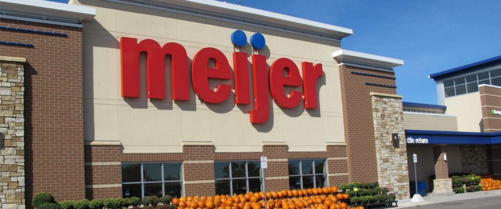 Front view of a Meijer store with a row of pumpkins displayed outside.