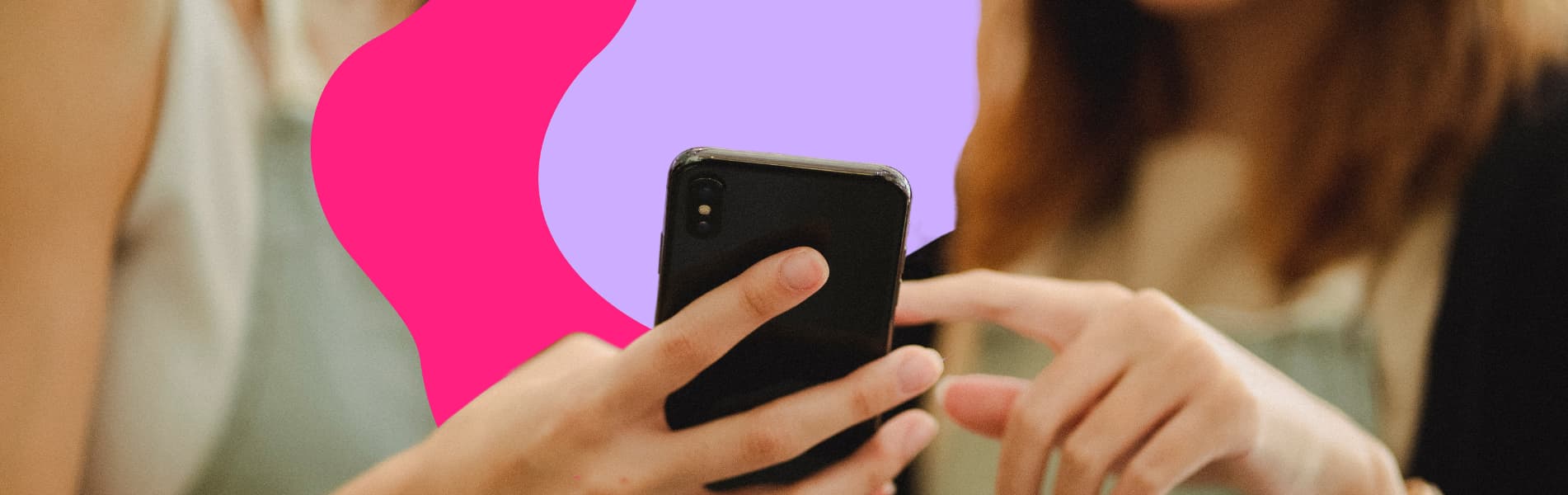 Two people hold a smartphone, one pointing at the screen. A pink and purple abstract design is in the background.