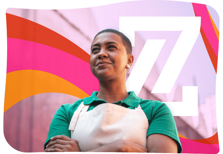 Person with short hair in a green shirt and apron stands confidently with arms crossed, set against a colorful background with red, orange, and pink waves and a large "Z" shape.