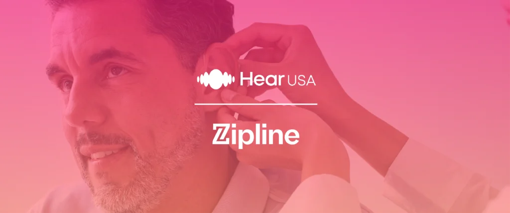 A person receives a hearing aid fitting from a professional, with "HearUSA" and "Zipline" logos displayed over a pink gradient background.