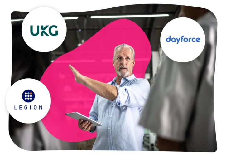 A man with a tablet gestures while standing indoors. Logos for UKG, Dayforce, and Legion are displayed around him on a pink abstract background.