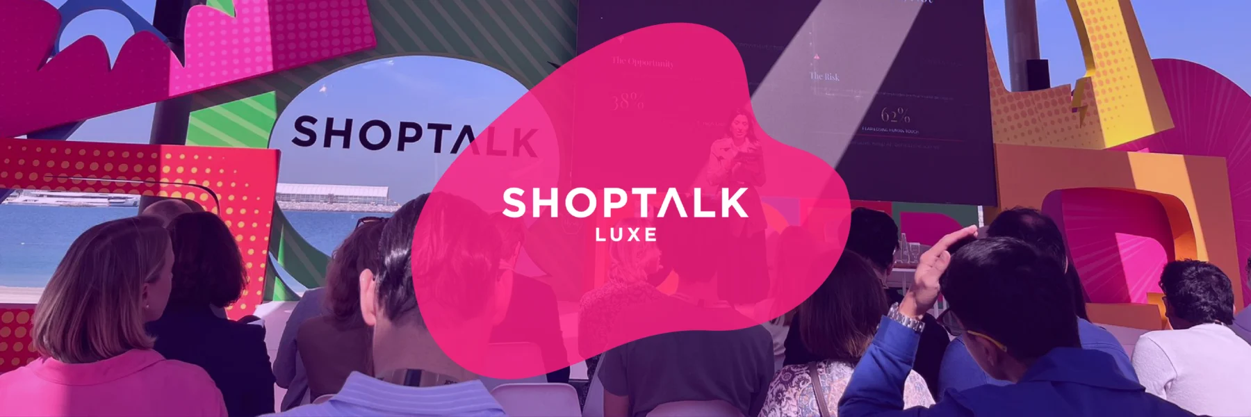 People are seated facing a stage at an outdoor event with colorful, geometric decorations and a "Shoptalk Luxe" logo overlay in the center.