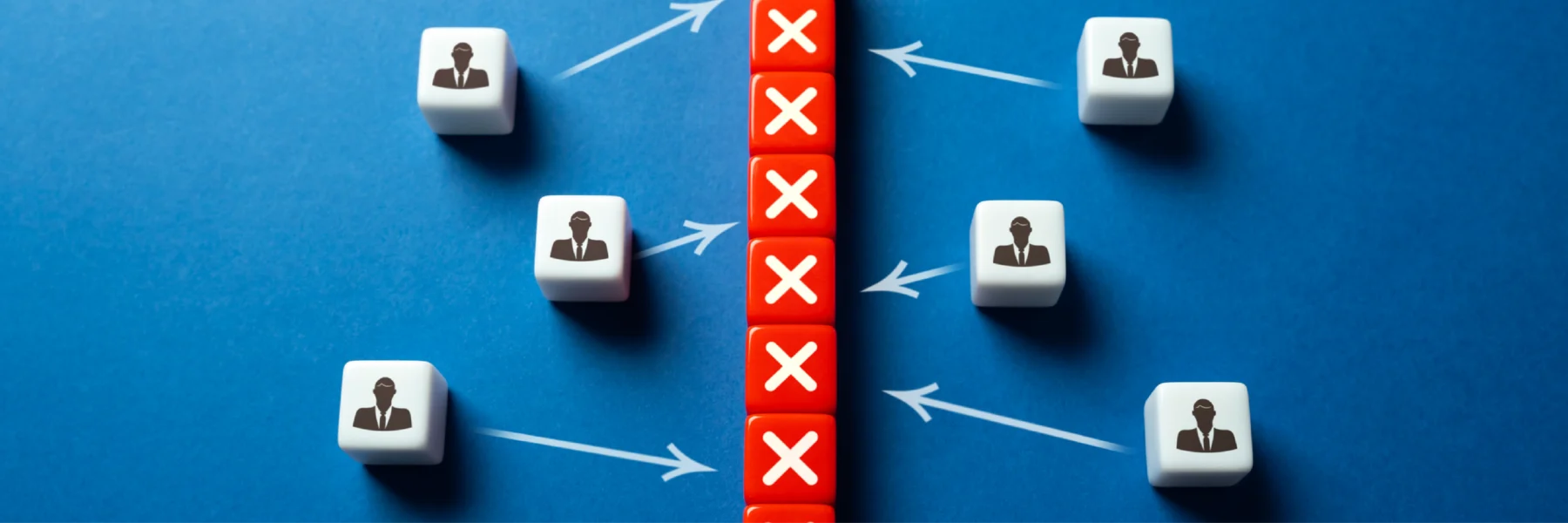 Six white cubes with businessperson icons face a vertical row of red cubes with white Xs, separated by arrows on a blue background, suggesting a barrier or blocked communication.