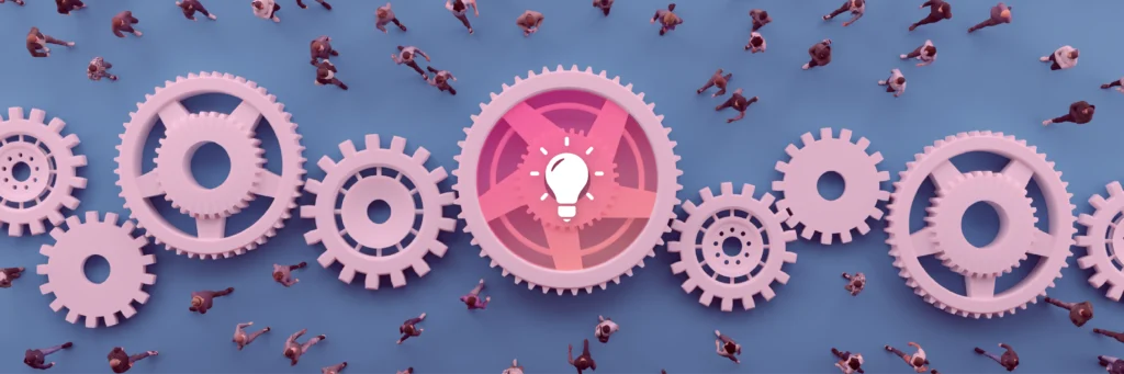 Aerial view of people walking around large interconnected gears, with a central gear featuring a light bulb icon.