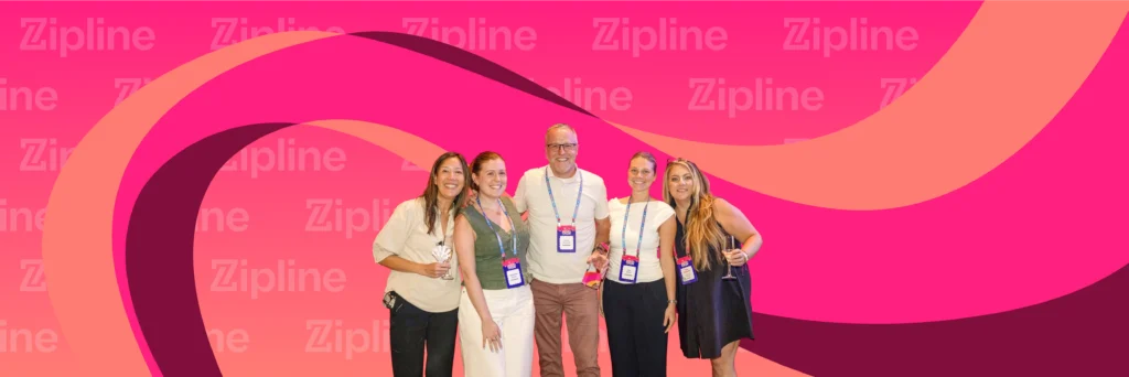 Five people pose together in front of a pink backdrop with "Zipline" text and abstract curved patterns; all are wearing badges.
