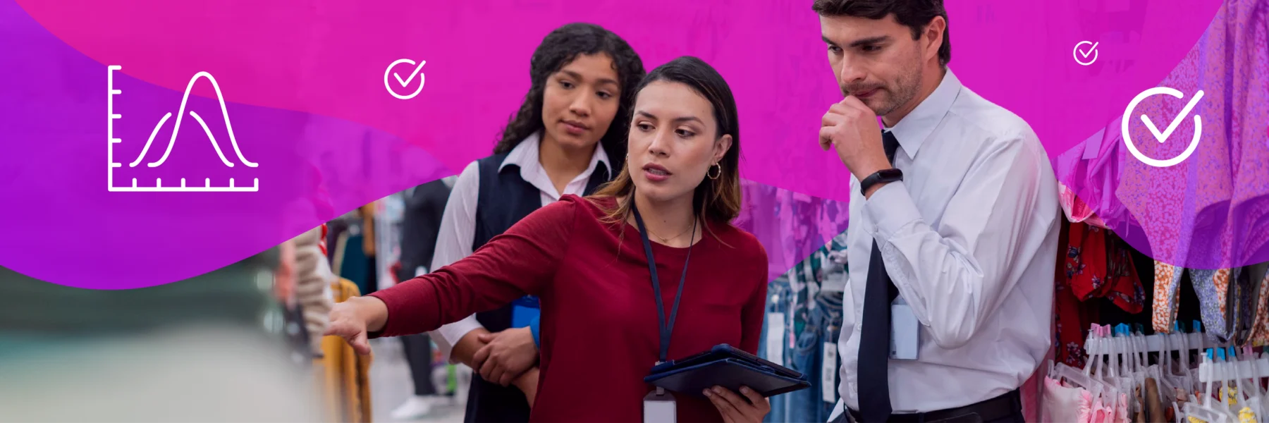 Three retail employees review inventory in a clothing store.